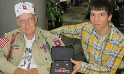 Nellis Ver Hey 82nd Airborne 508th PIR G Company with his Grandson Andrew Ver Hey receiving his ribbons at the Airport on our departure