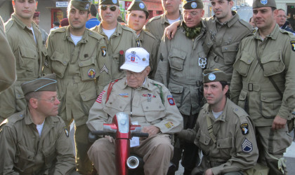 Re-enactors from the 82nd Airborne take time to talk with the real 82nd Airborne Veteran Nellis Ver Hey