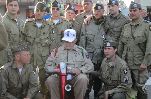 Re-enactors from the 82nd Airborne take time to talk with the real 82nd Airborne Veteran Nellis Ver Hey